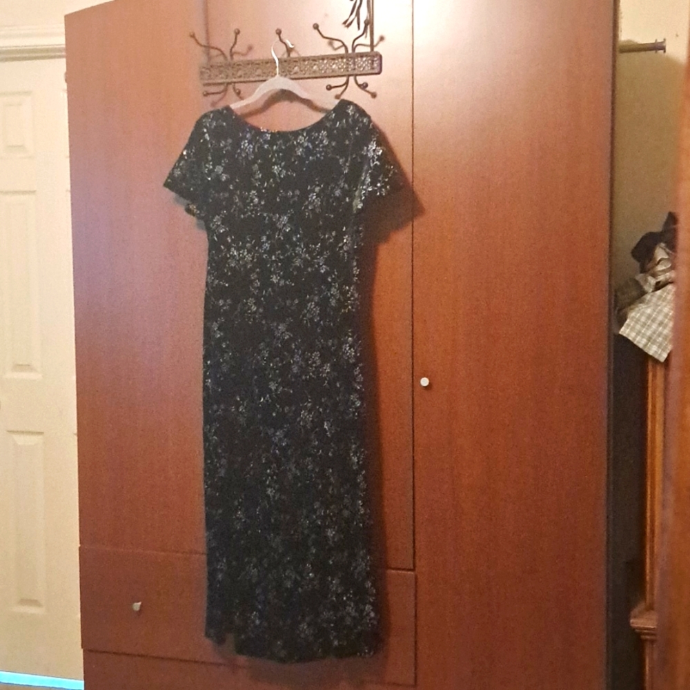 Long black and sparkles holiday dress with crisscross cut out in back.